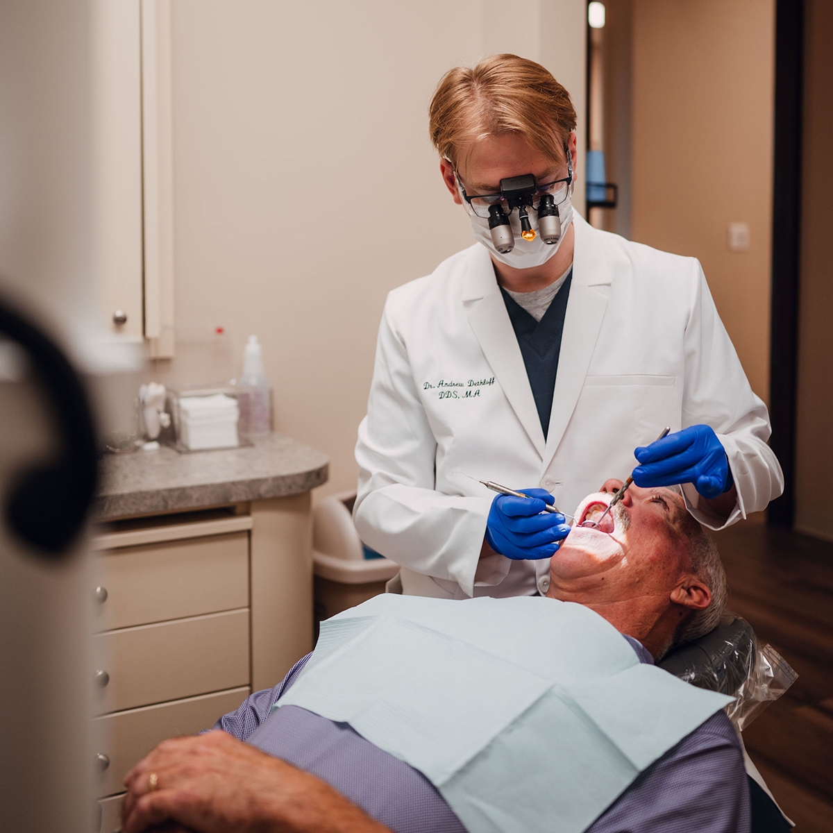Dentist inspecting a patient's mouth